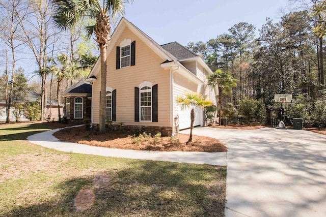 view of property exterior with a garage and a yard