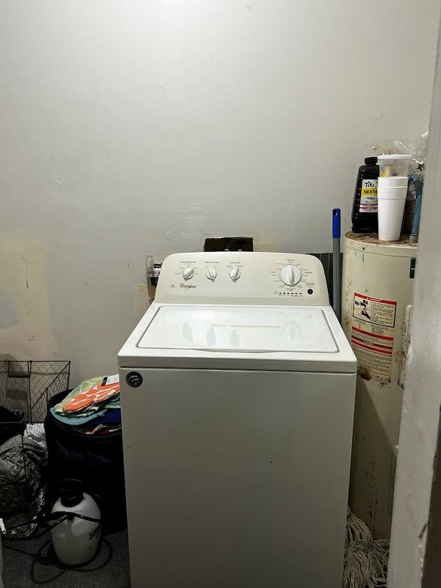 clothes washing area with washer / dryer and water heater