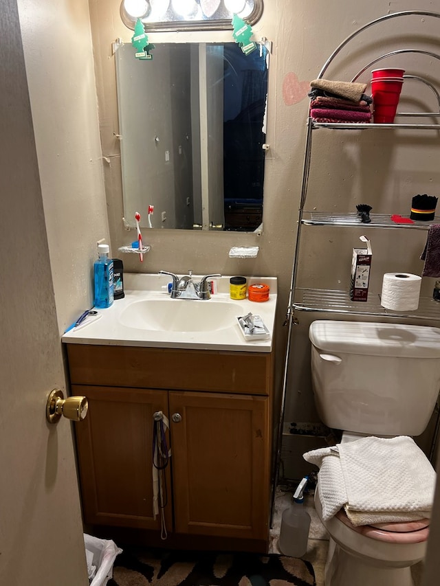 half bathroom with toilet and vanity