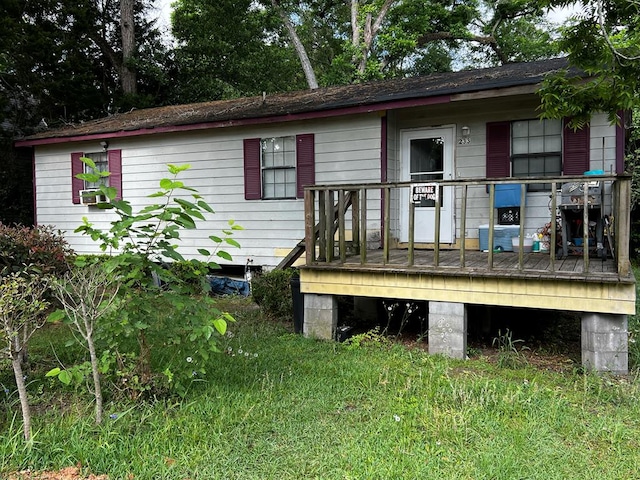 back of house featuring a wooden deck