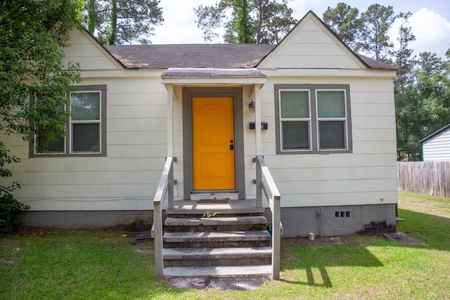 103 SW Weyt Ave, Cairo, GA 39828 - view of front of house with a front lawn, a shingled roof, crawl space, and fence