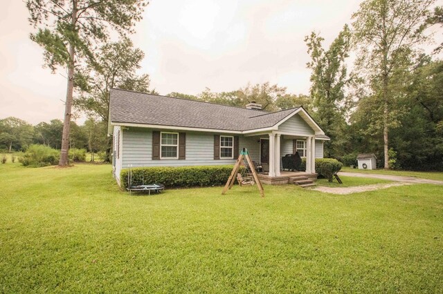 single story home with a shed and a front yard