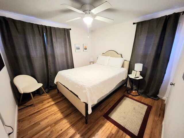 bedroom with ceiling fan and light hardwood / wood-style floors