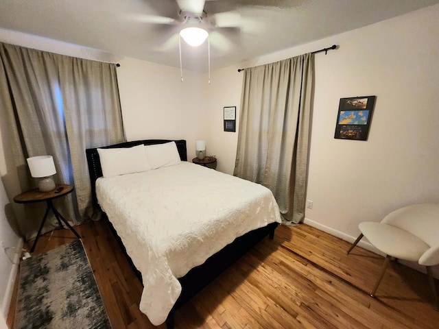 bedroom with ceiling fan and wood-type flooring