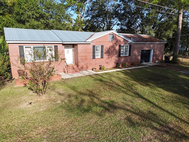 ranch-style home with a garage and a front lawn