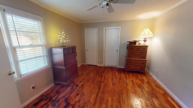 bedroom featuring crown molding, dark hardwood / wood-style floors, and ceiling fan