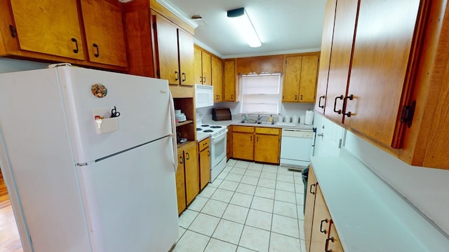 kitchen with light tile patterned flooring, sink, crown molding, and white appliances