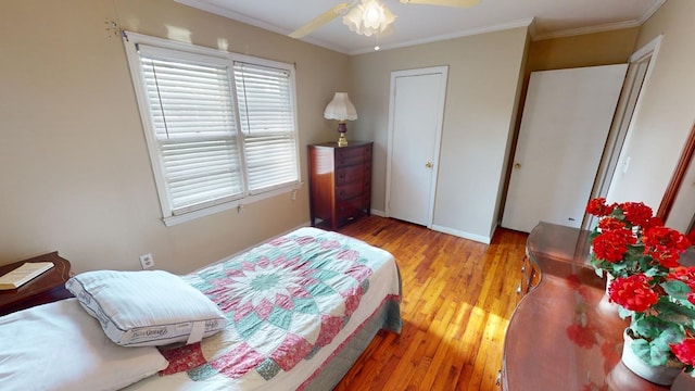 bedroom featuring crown molding and light wood-type flooring