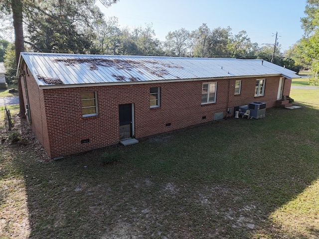 back of house with a yard and cooling unit