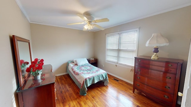 bedroom with ceiling fan, ornamental molding, and dark hardwood / wood-style floors