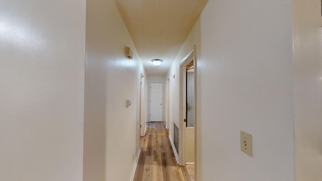 hall with light hardwood / wood-style floors