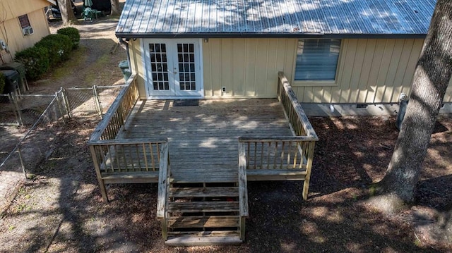 rear view of property with a wooden deck and french doors