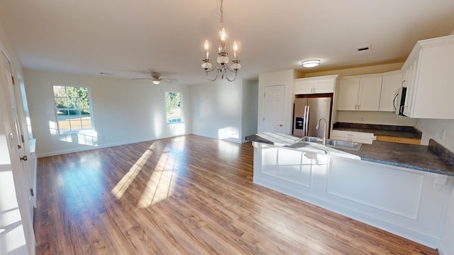 40 Beacon St, Camilla, GA 31730 - kitchen with stainless steel appliances, a chandelier, a sink, dark countertops, and ceiling fan