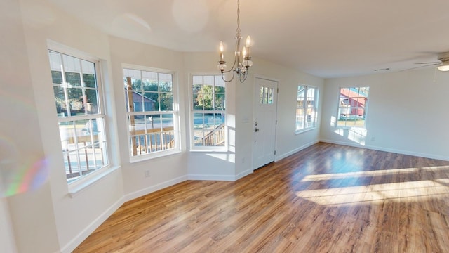 40 Beacon St, Camilla, GA 31730 - unfurnished dining area featuring healthy amount of natural light, wood finished floors, a chandelier, and baseboards