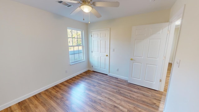 40 Beacon St, Camilla, GA 31730 - unfurnished bedroom with wood finished floors, baseboards, and a ceiling fan