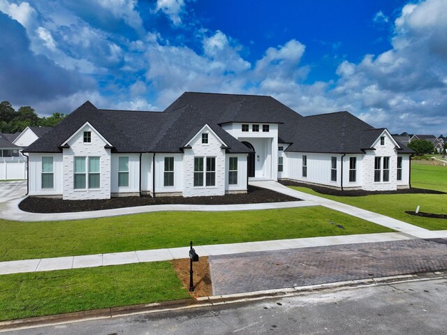 347 Madison Grv, Thomasville, GA 31757 - view of front of property featuring a front yard, roof with shingles, and stone siding