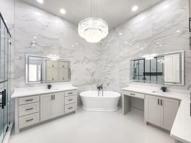347 Madison Grv, Thomasville, GA 31757 - full bath featuring a freestanding tub, a shower stall, a chandelier, two vanities, and tile walls