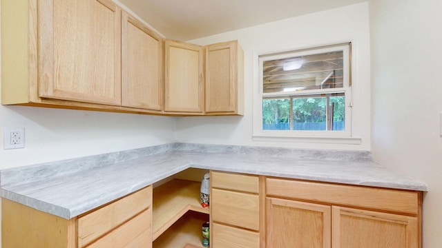 193 E Live Oak Cir, Thomasville, GA 31792 - kitchen featuring light brown cabinetry, built in desk, and light countertops