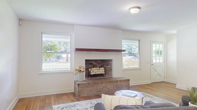 193 E Live Oak Cir, Thomasville, GA 31792 - living room with healthy amount of natural light, wood finished floors, and a fireplace