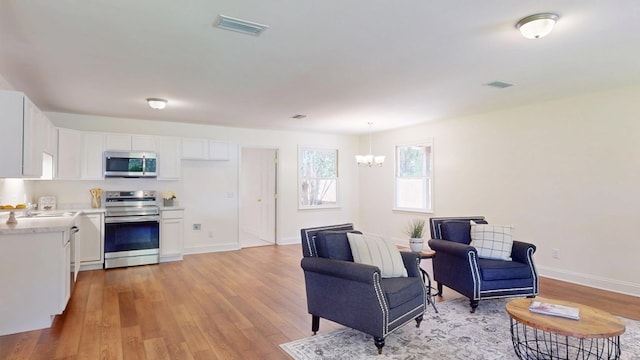 193 E Live Oak Cir, Thomasville, GA 31792 - living area with a chandelier and light wood-style floors