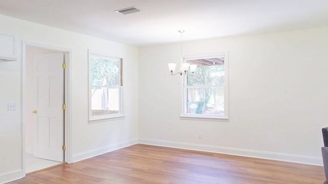 193 E Live Oak Cir, Thomasville, GA 31792 - unfurnished dining area featuring a chandelier, healthy amount of natural light, and light wood-style floors