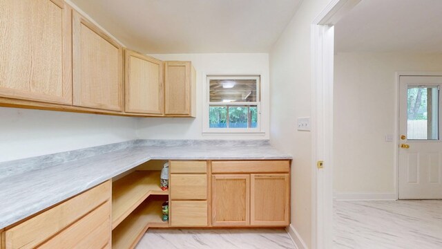 193 E Live Oak Cir, Thomasville, GA 31792 - kitchen featuring light brown cabinetry, built in desk, light countertops, and healthy amount of natural light