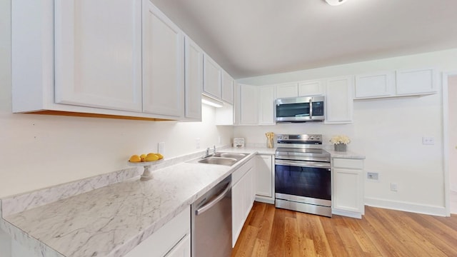 193 E Live Oak Cir, Thomasville, GA 31792 - kitchen with appliances with stainless steel finishes, white cabinets, light wood-type flooring, and light countertops