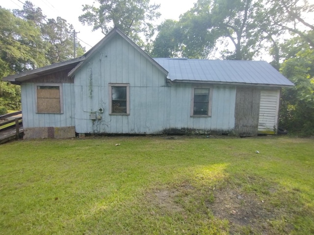 544 W Clay St, Thomasville, GA 31792 - view of side of home with board and batten siding, a yard, and metal roof