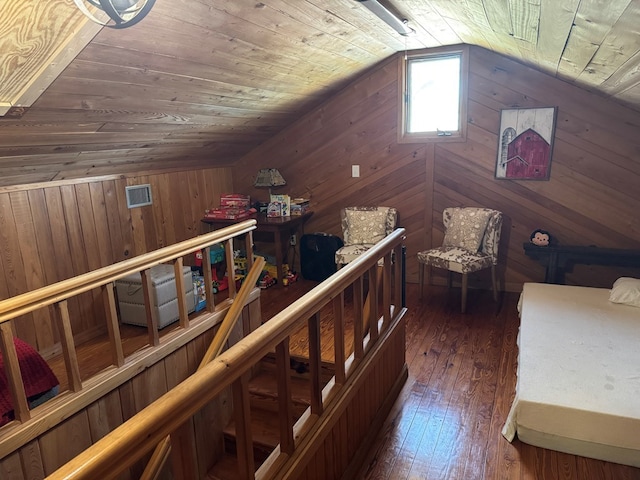 unfurnished bedroom with hardwood / wood-style floors, vaulted ceiling, wooden walls, and wood ceiling