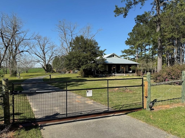 view of gate featuring a yard and fence