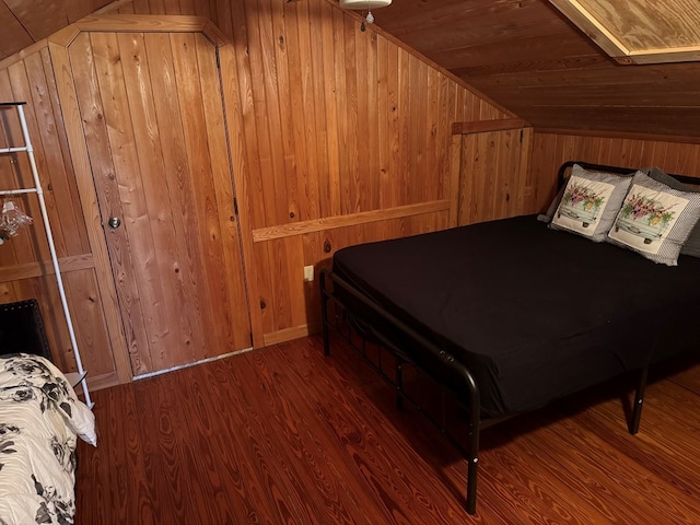 bedroom featuring wood ceiling, wood finished floors, vaulted ceiling, and wood walls