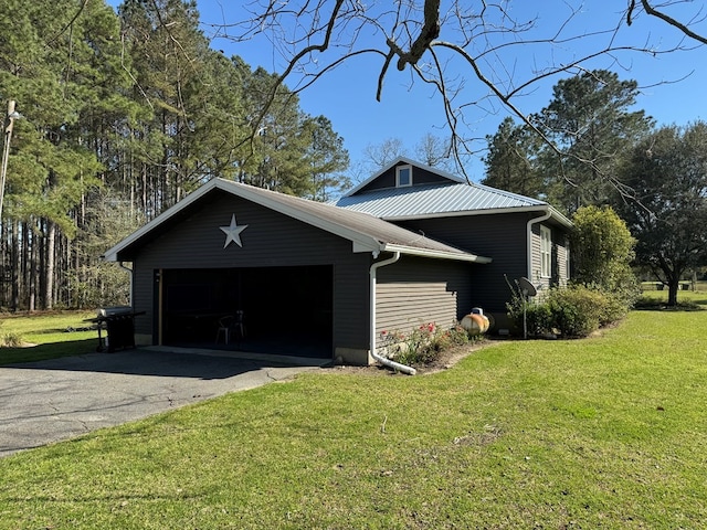 view of home's exterior featuring a lawn and a garage