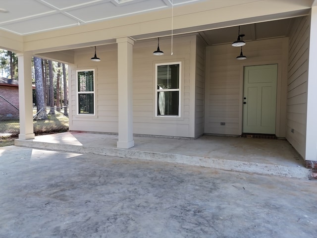 property entrance featuring a patio area