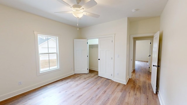 unfurnished bedroom with light wood-style floors, baseboards, and a ceiling fan