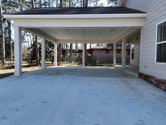 view of patio / terrace with driveway and a carport