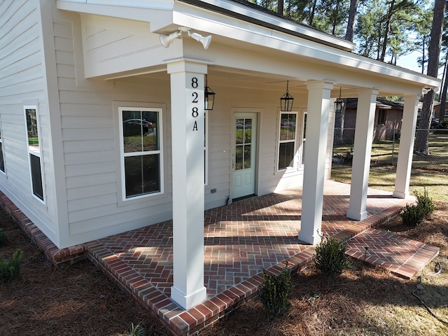 view of exterior entry featuring brick siding