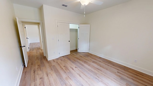 unfurnished bedroom with ceiling fan, visible vents, baseboards, a closet, and light wood-type flooring