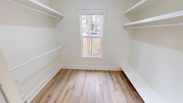 spacious closet featuring light wood-style flooring