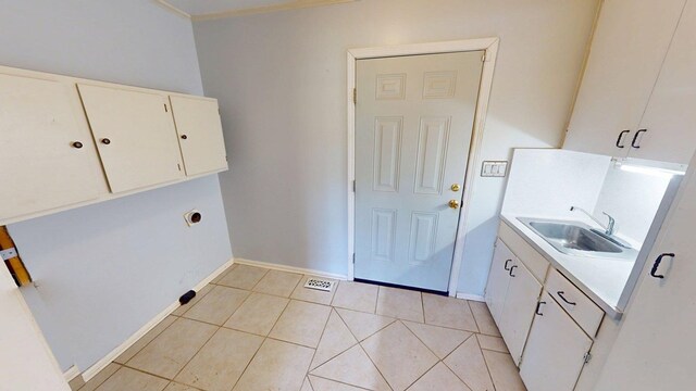 610 Partridge Dr, Thomasville, GA 31792 - laundry room with a sink, light tile patterned floors, and baseboards