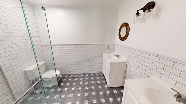 610 Partridge Dr, Thomasville, GA 31792 - full bath with tile walls, vanity, a wainscoted wall, a shower stall, and ornamental molding