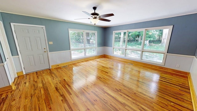 610 Partridge Dr, Thomasville, GA 31792 - empty room with wood finished floors, ceiling fan, and wainscoting