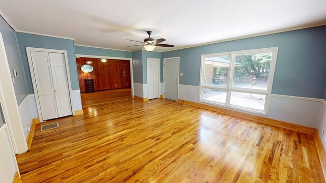 610 Partridge Dr, Thomasville, GA 31792 - unfurnished room featuring wood finished floors, ceiling fan, ornamental molding, baseboards, and wainscoting