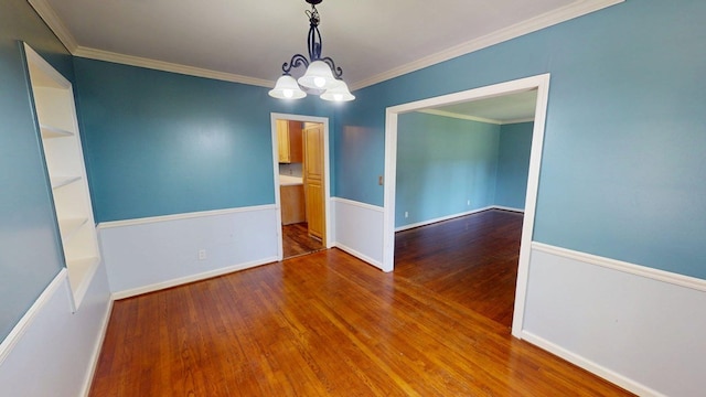610 Partridge Dr, Thomasville, GA 31792 - spare room featuring wood finished floors, a chandelier, crown molding, and baseboards