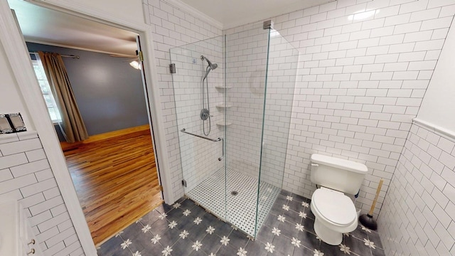 610 Partridge Dr, Thomasville, GA 31792 - full bath with a stall shower, ornamental molding, tile walls, toilet, and ceiling fan
