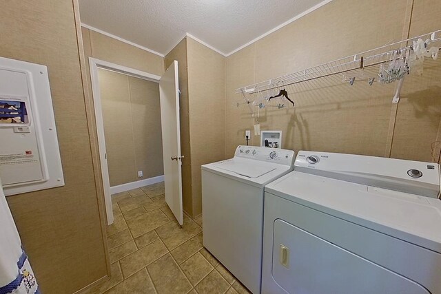 3024 Willow St, Ochlocknee, GA 31773 - laundry area featuring washing machine and dryer, ornamental molding, electric panel, and a textured ceiling