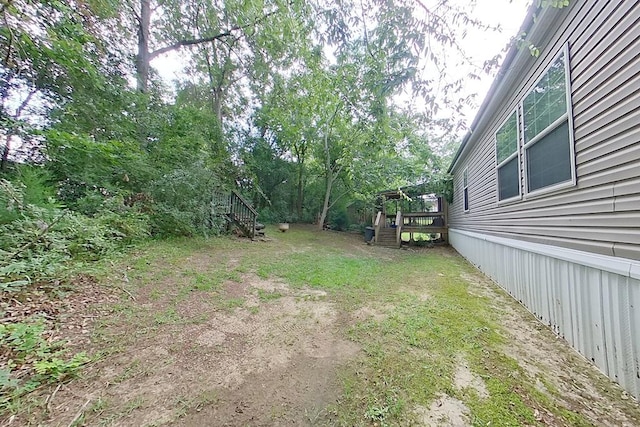 3024 Willow St, Ochlocknee, GA 31773 - view of yard featuring stairway and a wooden deck