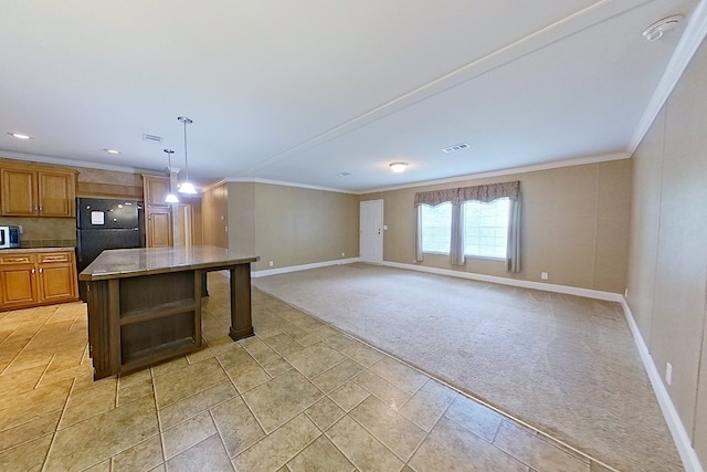 3024 Willow St, Ochlocknee, GA 31773 - kitchen featuring freestanding refrigerator, light colored carpet, crown molding, brown cabinetry, and decorative light fixtures