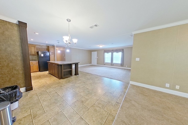 3024 Willow St, Ochlocknee, GA 31773 - kitchen with freestanding refrigerator, ornamental molding, open floor plan, a chandelier, and a kitchen island
