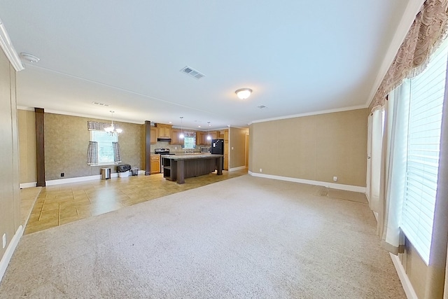 3024 Willow St, Ochlocknee, GA 31773 - unfurnished living room with crown molding, a chandelier, and light carpet