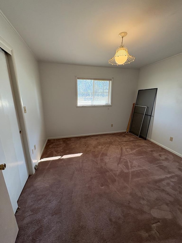 unfurnished bedroom featuring carpet flooring and baseboards